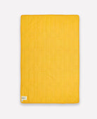 back of tile baby quilt in solid mustard yellow