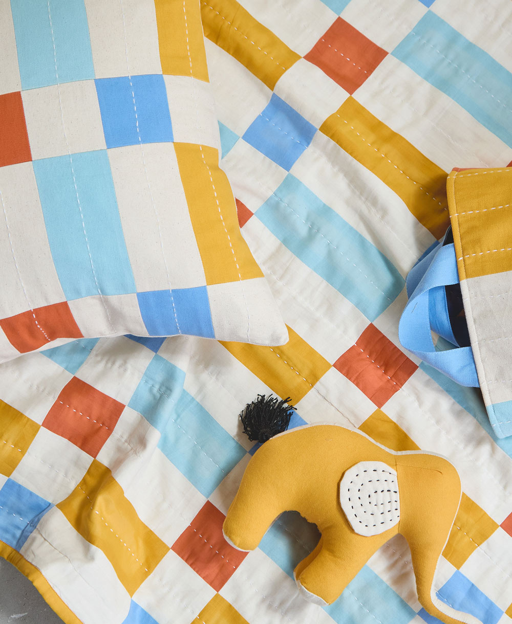 tile baby quilt with handmade elephant stuffed animal