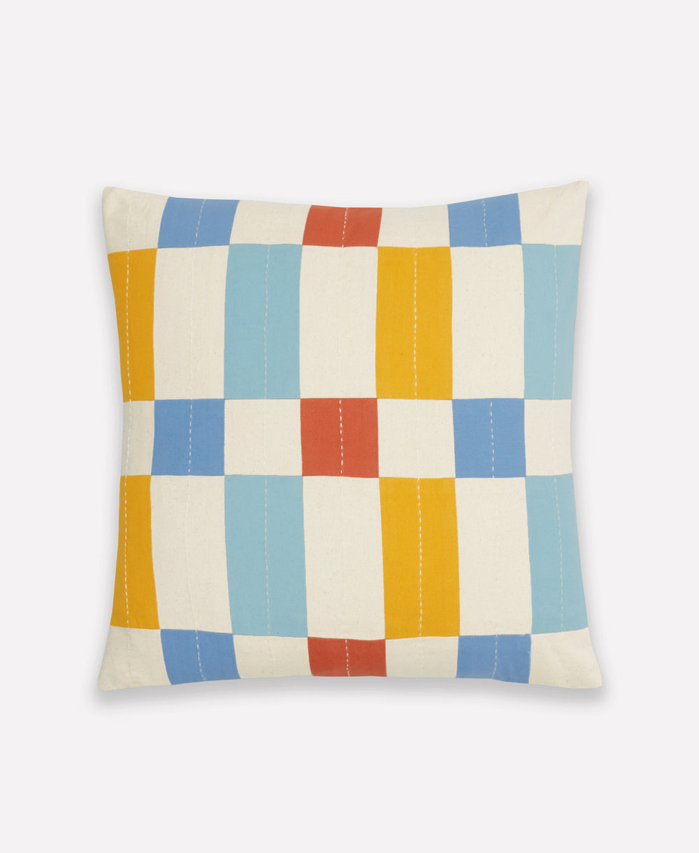 Checkered throw pillow with multicolored squares on a white background