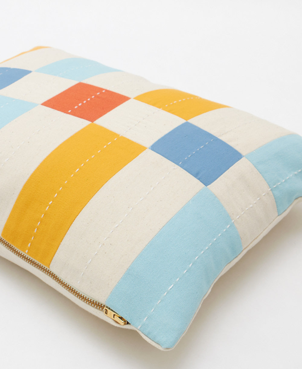 Colorful patchwork small pillow with a zipper on a white background