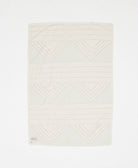 Textured white fabric with geometric pattern on a white background