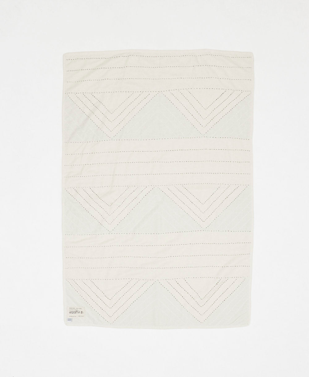 Textured white fabric with geometric pattern on a white background