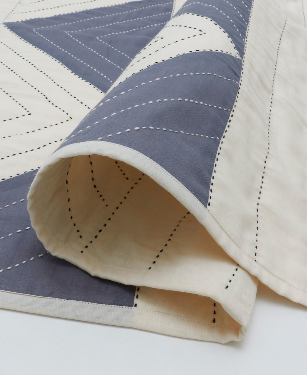 slate blue and off-white organic cotton baby quilt with black kantha embroidery