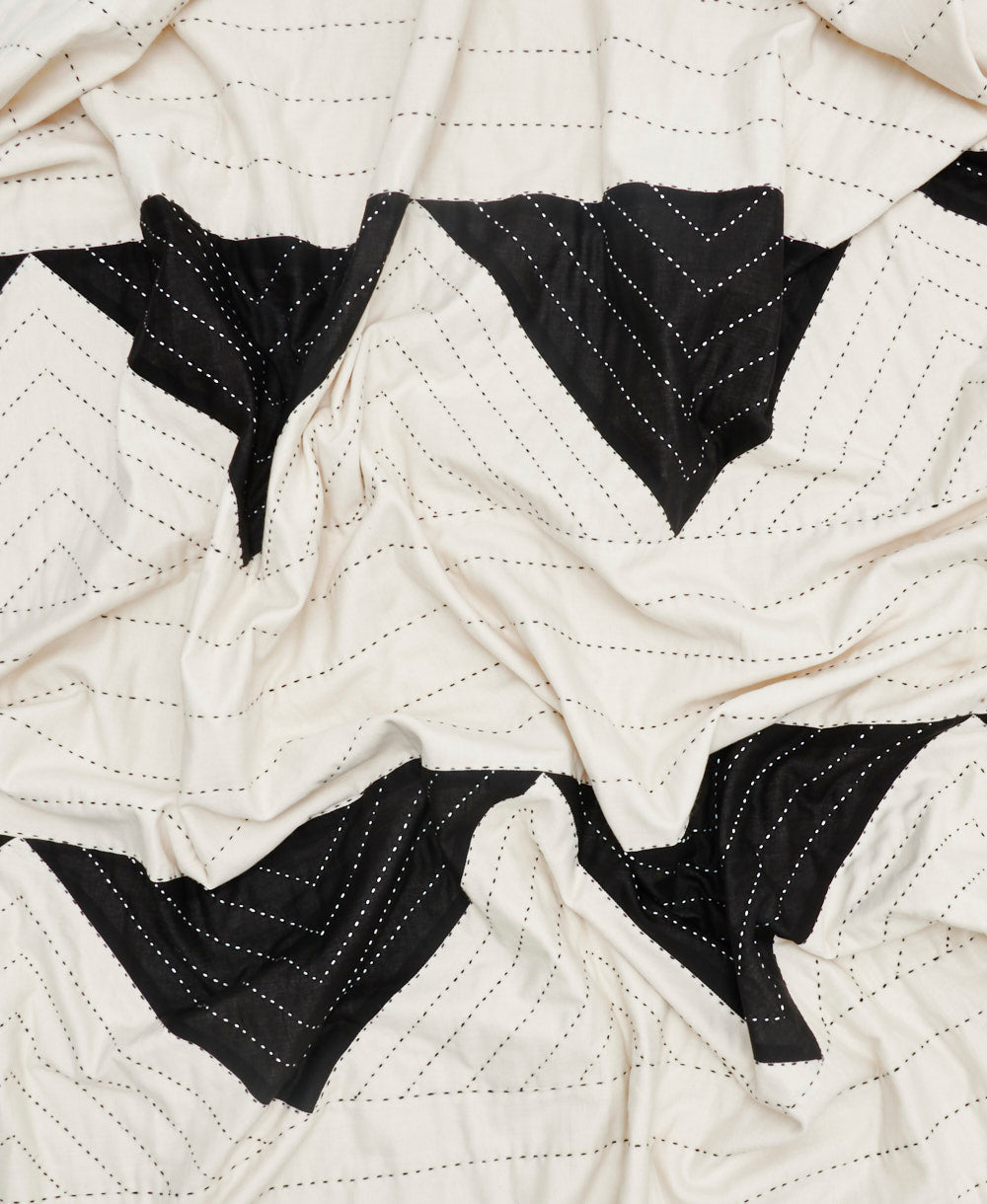 Close-up of a quilt with black and white chevron pattern