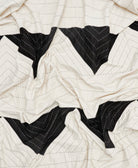 Close-up of a quilt with black and white chevron pattern