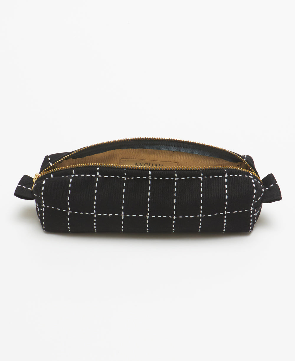 handmade small toiletry bag in black with canvas lining and white grid-stitch pattern