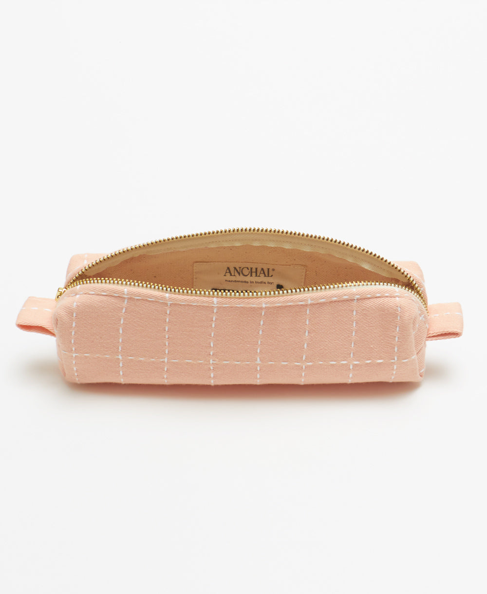 small toiletry bag in baby pink with white grid-stitch pattern embroidery