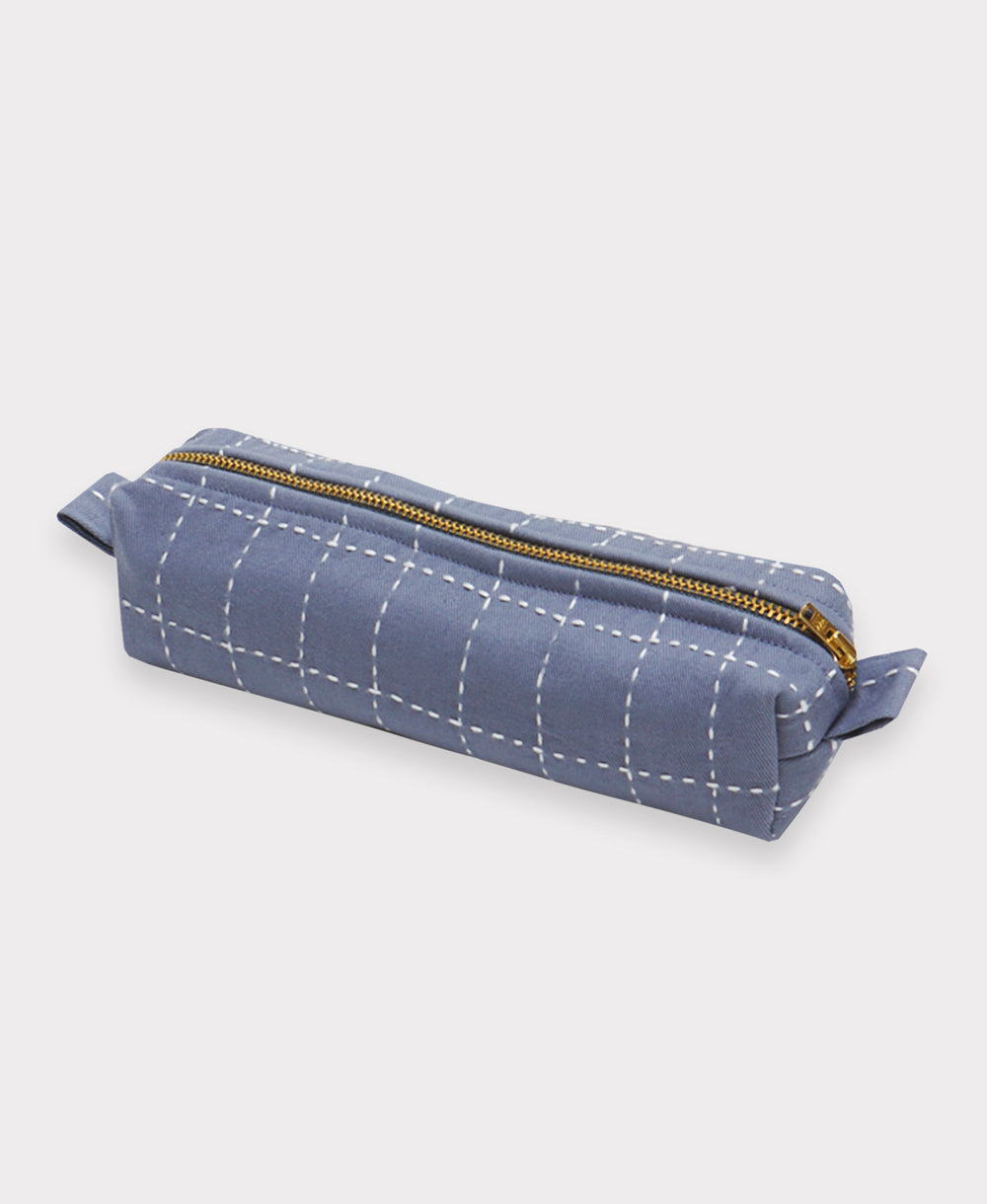 slate blue small toiletry bag with white hand-embroidery