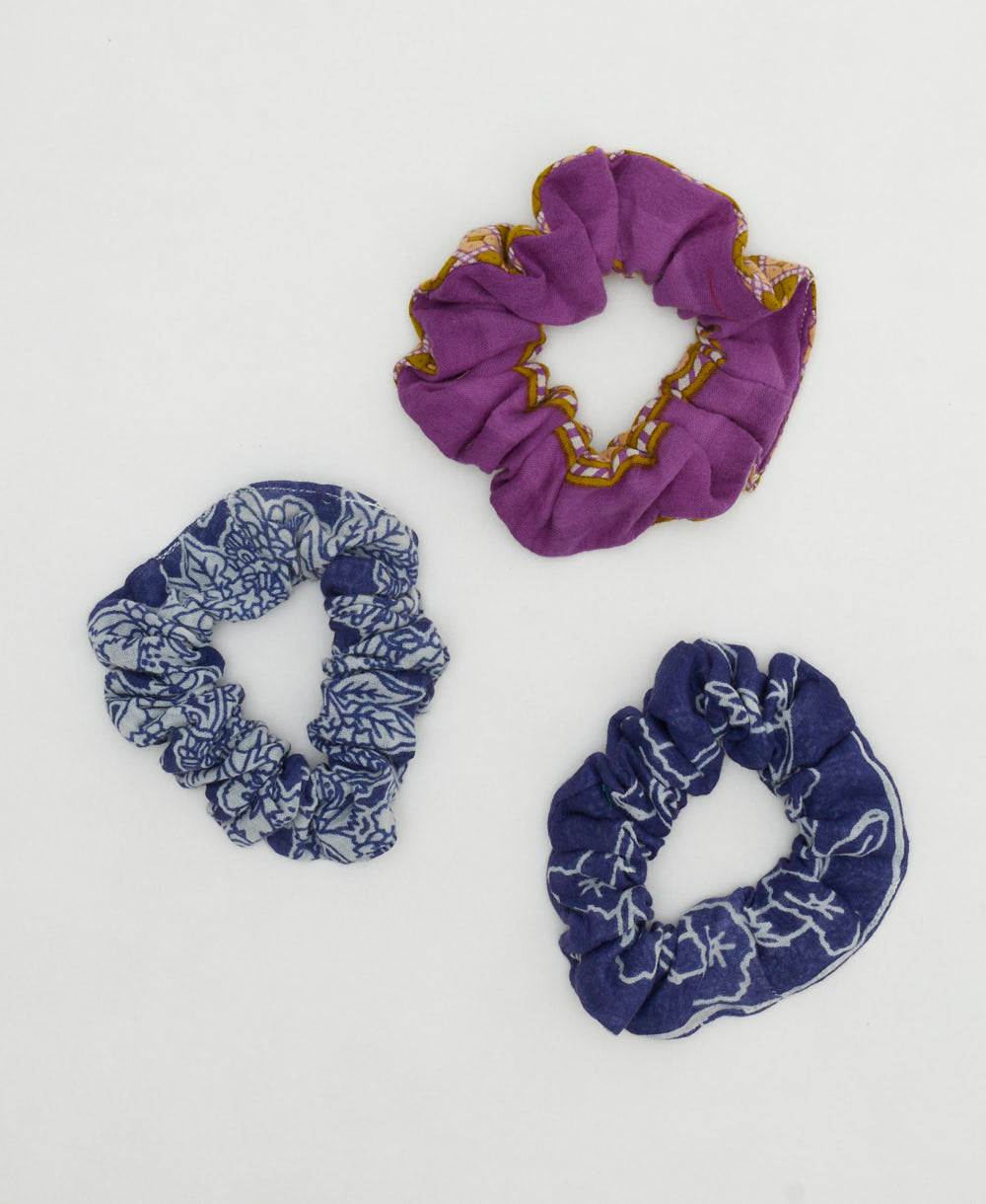 group of three vintage cotton scrunchies in blue and purple colorways against a white background