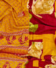 King kantha quilt with reversible orange floral pattern
