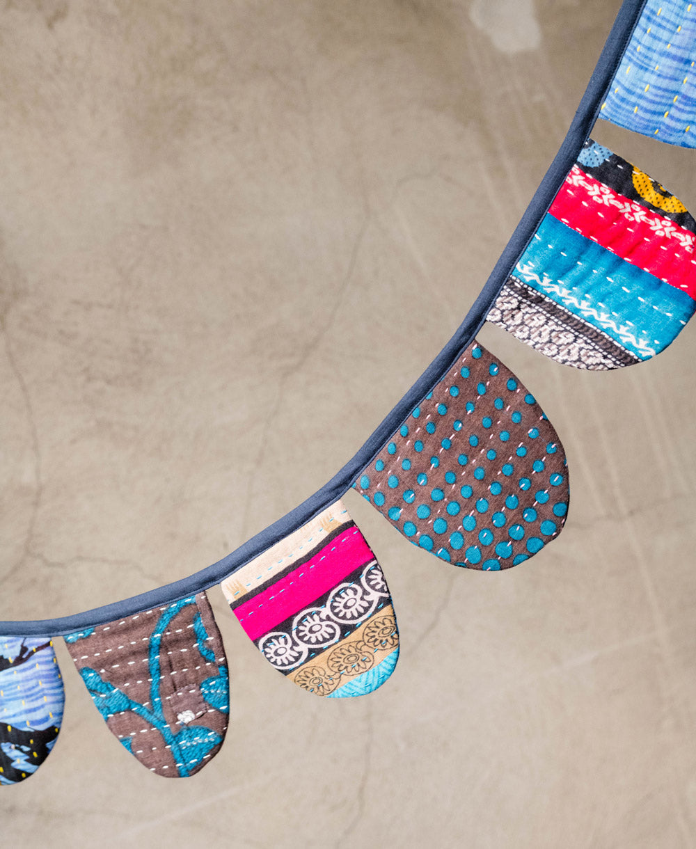 blue bunting in scallop shape draped over a neutral background