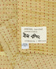 Beige small Kantha quilt throw featuring the hand-stitched
signature of the maker