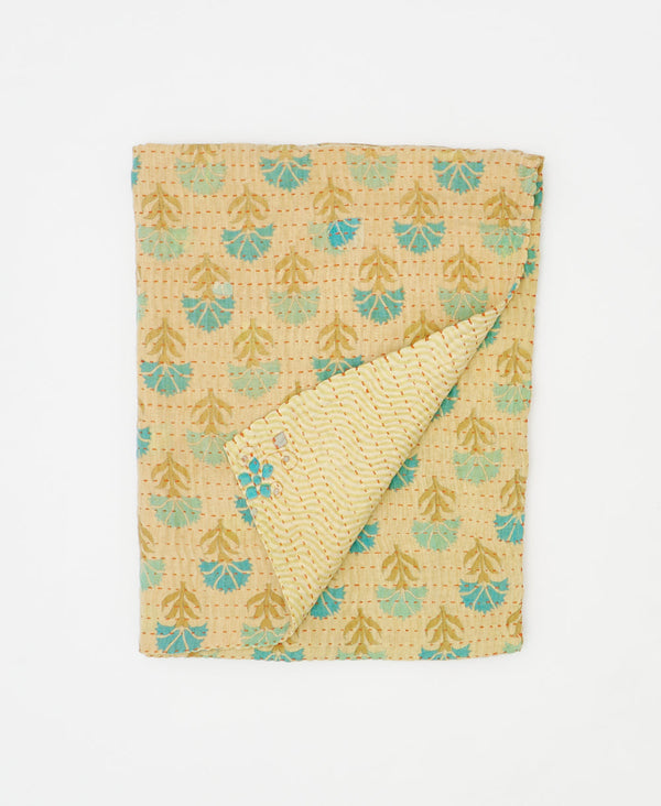 Blue and tan quilt throw made using floral print 
recycled vintage saris