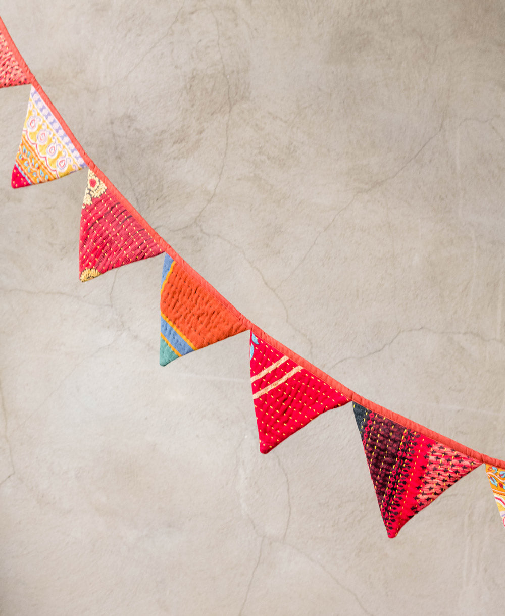 triangle bunting handmade from fabric in India in an orange and red hue