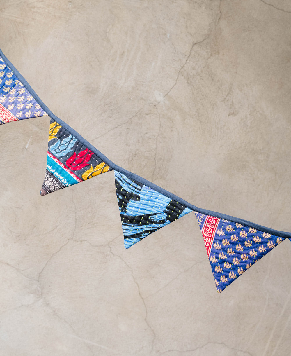 blue triangle bunting draped over a neutral wall