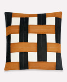 Decorative pillow with black and camel stripes on a white background