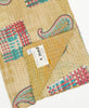beige kantha quilt throw featuring the handstitched signature of the maker 