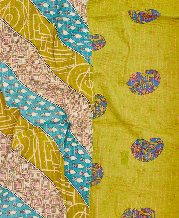 Featuring contrasting pink, green, and blue paisley and stripe prints, this is a unique one-of-a-kind small throw 