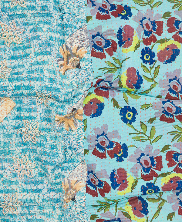 Contrasting blue floral patterns make this small throw quilt a unique one-of-a-kind piece 