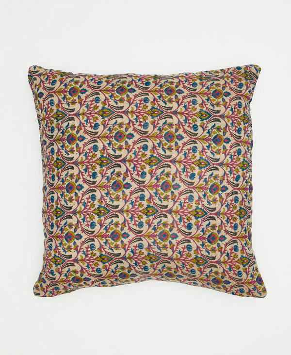 white cotton throw pillow with pink, blue, and green swirling patterns
