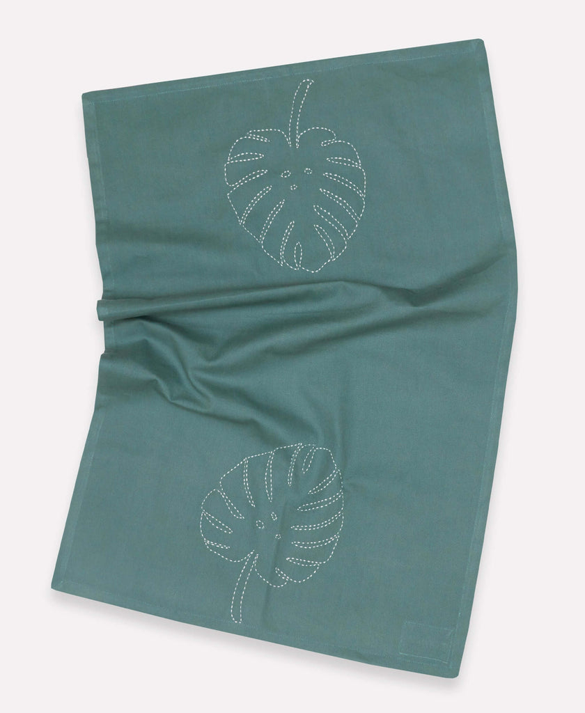 Leaf embroidered kitchen towel featuring white stitching made by Anchal artisans 