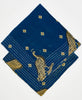 two dark blue cotton bandanas with yellow and black birds stacked on top of each other to show the difference in thread color. One bandana has yellow kantha stitching along its edges while the other has white kantha stitching along its edges