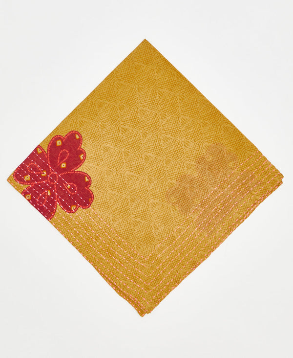 mustard yellow cotton bandana with large red clover and pink traditional kantha stitching along its edges