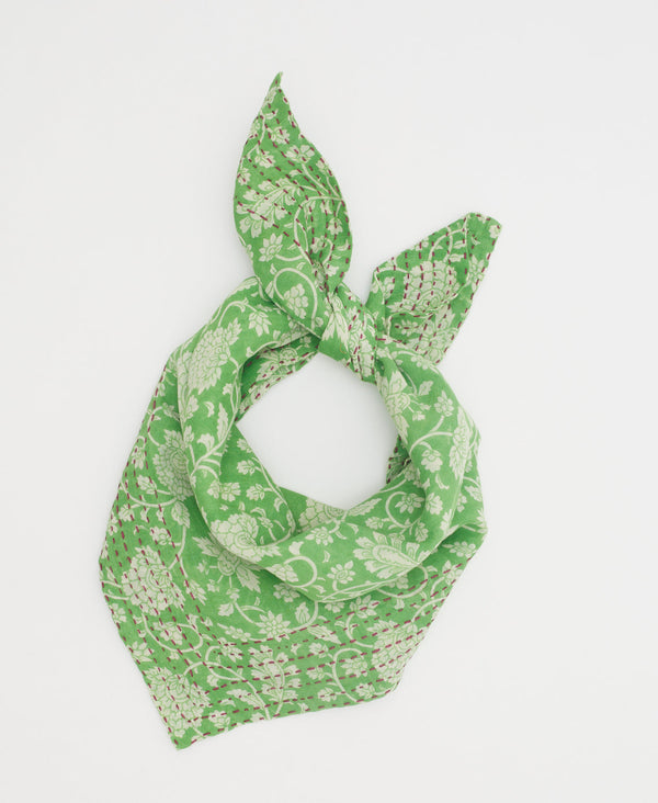 Green cotton bandana featuring a white floral print and pink kantha stitching 