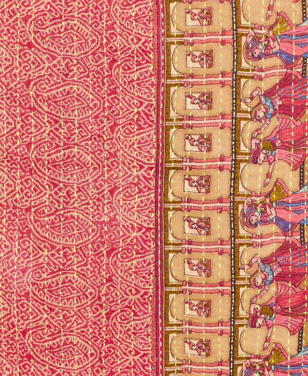 cotton infinity scarf features beige paisleys on a red background and an intricate scene of women dancing in red, purple, and pink dresses in a great hall with columns and stitched using neon yellow thread