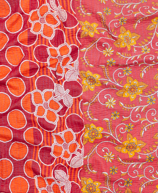 Red, orange, yellow, and white contrasting floral patterns on a small hand crafted throw 