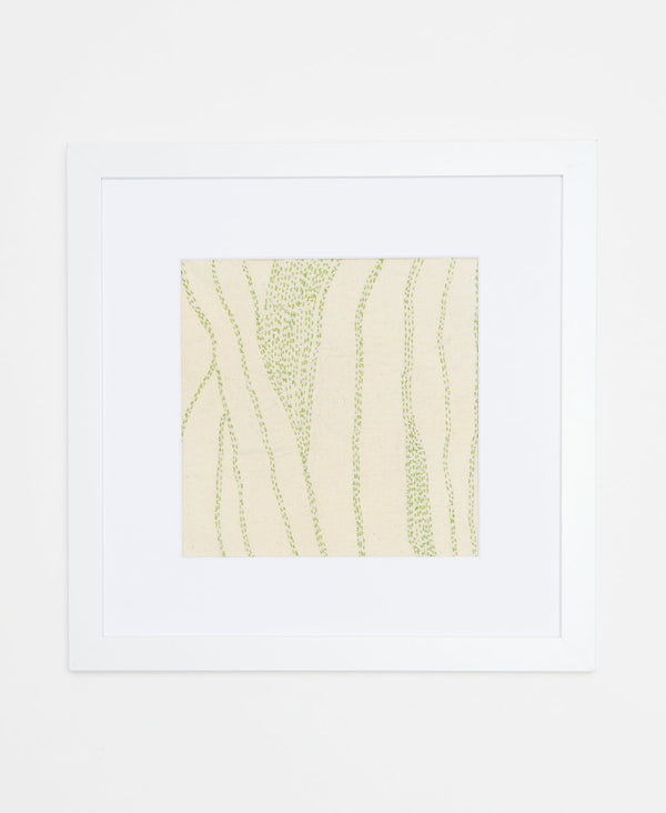 Handcrafted artisan-made textile art featuring detailed light green line stitching on a cream background l