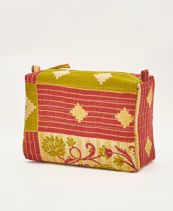 Eco-friendly artisan made make up bag featuring a bold red and green pattern 