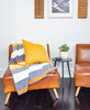 organic cotton striped throw on mid-century modern leather chair