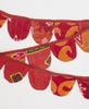 fair trade and artisan-made red and orange garland made of scraps of vintage cotton saris