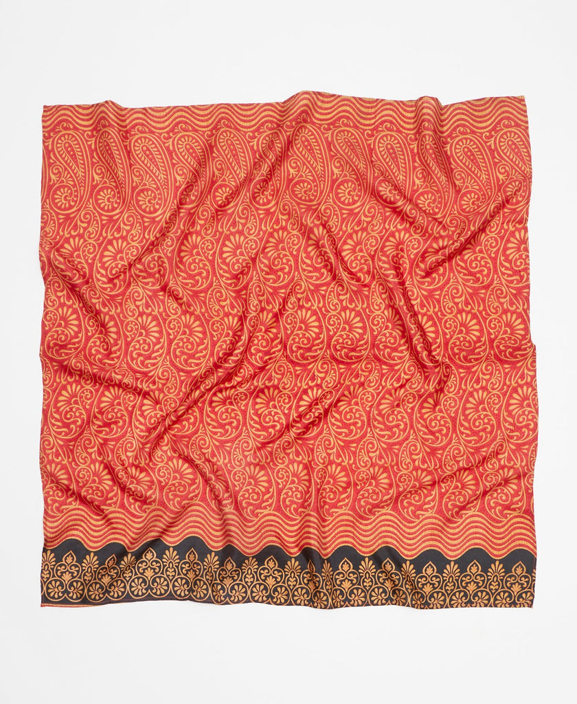 Red and gold printed silk square scarf with a contrasting black pattern along the edge