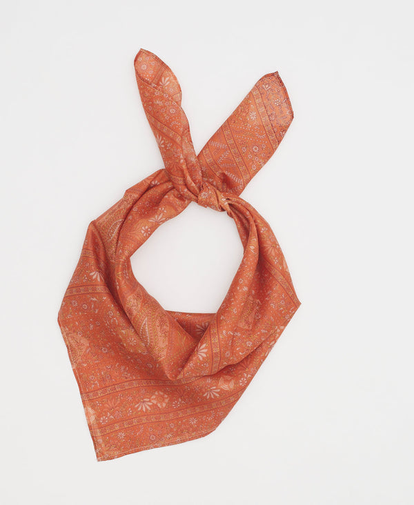 Orange silk square scarf featuring an understated cream floral and paisley print 