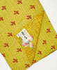 Yellow vintage quilt throw featuring red traditional knahta hand stitching 