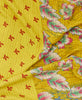 Red, yellow, and pink floral eco friendly quilt throw created using repurposed saris 