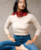 woman in cream sweater, jeans, and a red Anchal vintage silk bandana tied around her necl