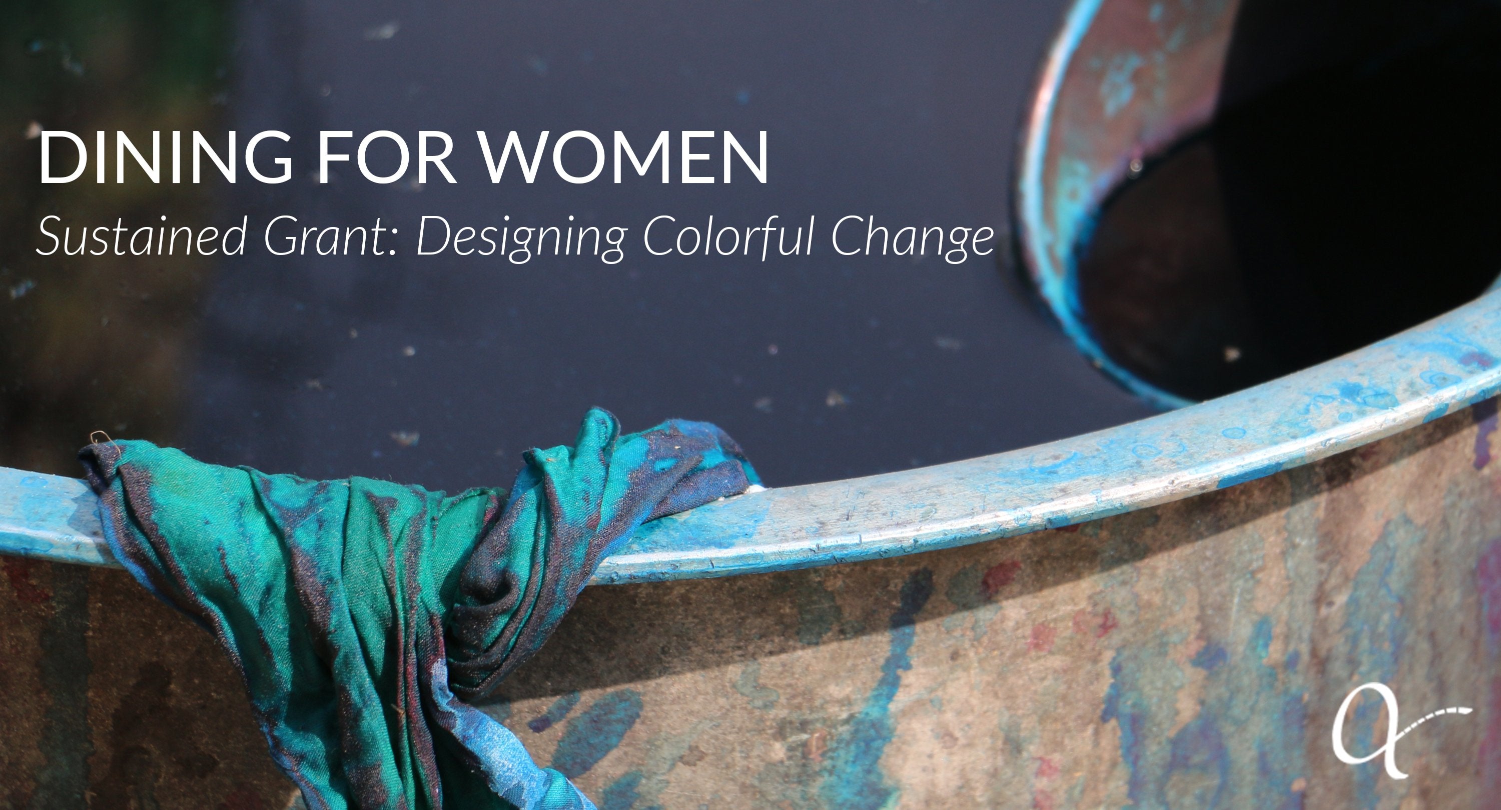 Bucket of dye with teal fabric hanging over the edge, celebrating the grant received from Dining For Women