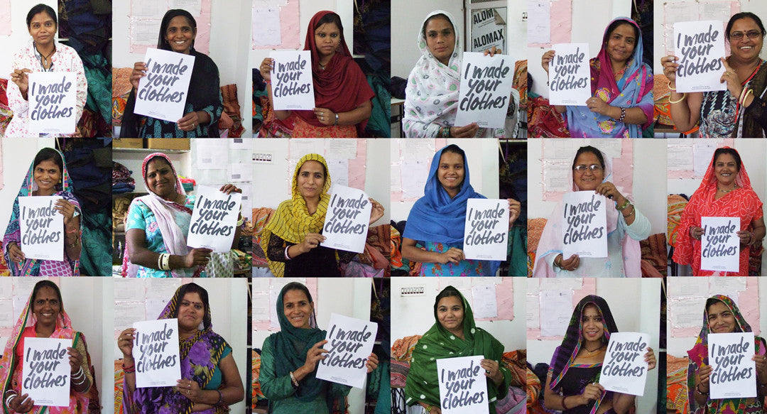 Eighteen artisan women, each holding a sign that says I made your clothes