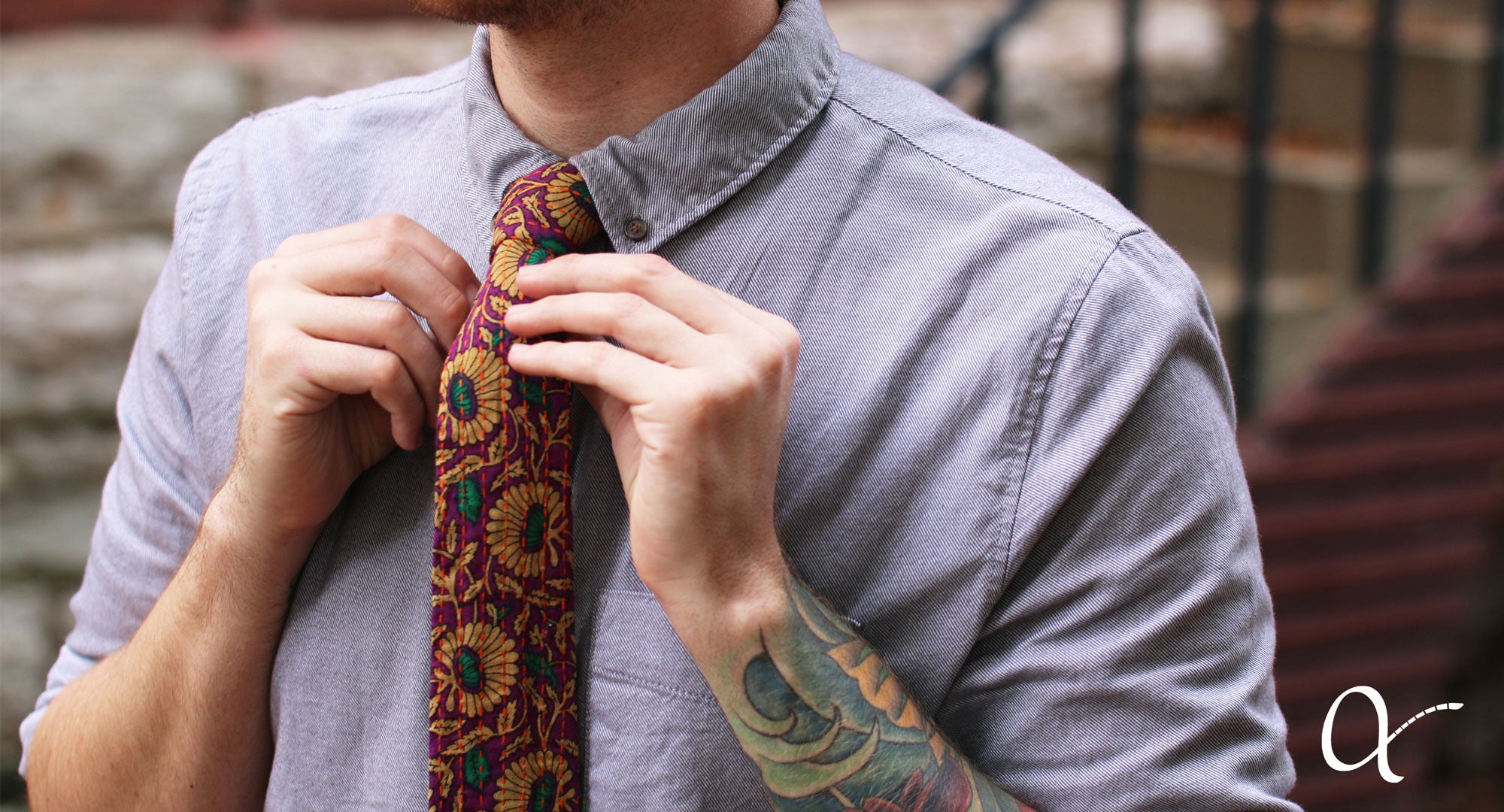 Man in a dress shirt accessorizing with an Anchal tie 