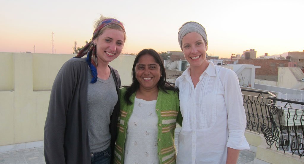 Colleen Clines and Manju on the rooftop smiling after a long day of work 