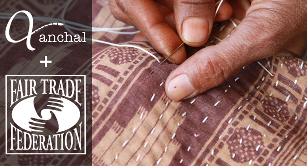 Hand sewing an intricate pattern into brown fabric with Anchal and Fair Trade Federation logos overlaid to celebrate the acceptance of Anchal Project into the Fair Trade Federation
