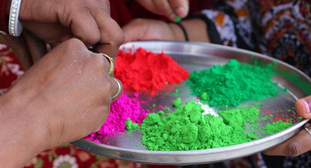 Pink, lime green, red, and dark green powder used for traditional celebrations of Holi