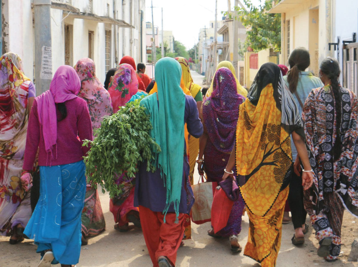 Women walking down the street in various colorful saris