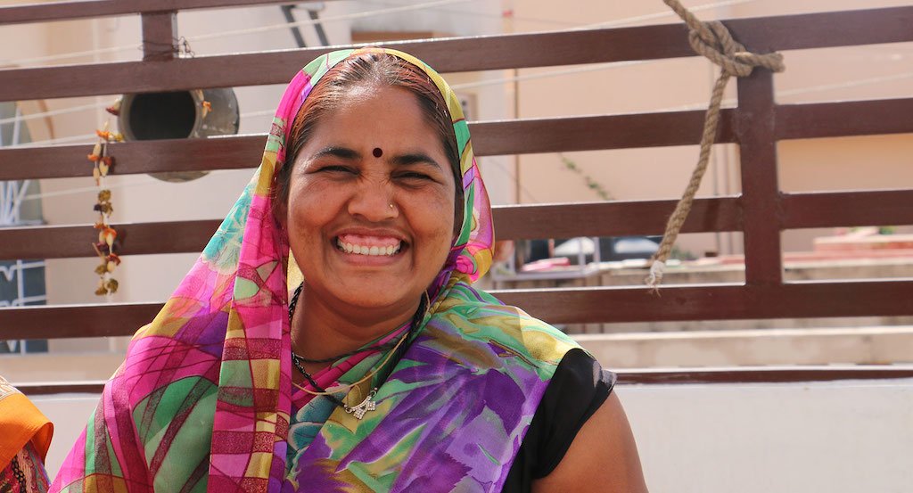 Maya, a female artisan, smiling with joy