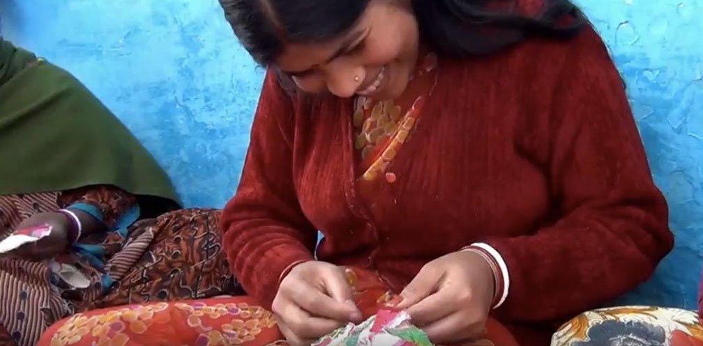 One of Anchal's newest artisans hand sewing a pattern