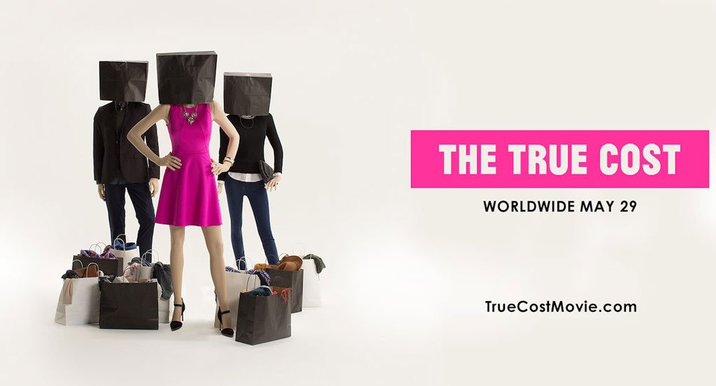 The cover for the documentary, The True Cost. 3 people with shopping bags over their heads surrounded by shopping bags full of clothing