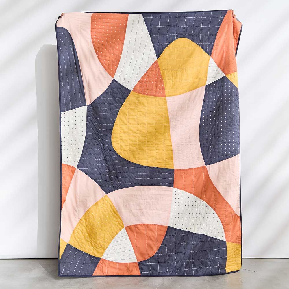 beautiful modern kantha quilt with abstract patchwork shapes in navy, orange, yellow, pink and white by Anchal